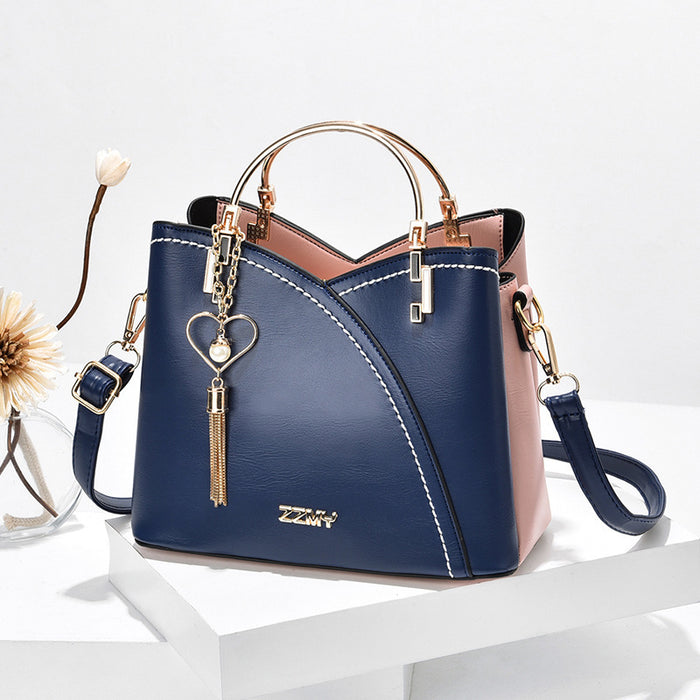 Stella | Handväska i colour block med hjärtberlock